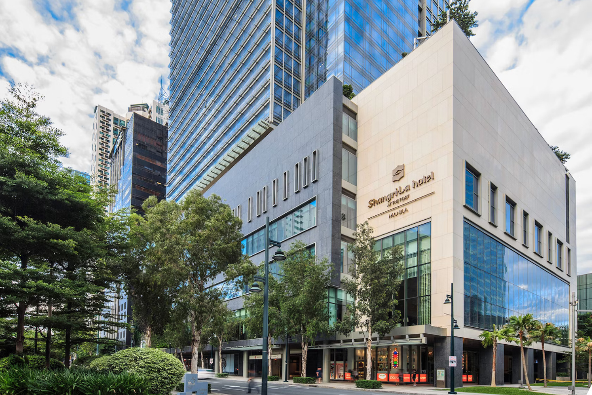 Facade of Shangri-La The Fort BGC, a luxury hotel in Manila, showcasing its modern glass architecture and towering structure illuminated against the Bonifacio Global City skyline.